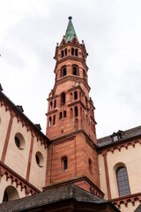 Fototapeta na wymiar Brick colored towers with bronze green roofs at Würzburger Cathedral or Würzburger Dom seen in frog perspective from the nave side