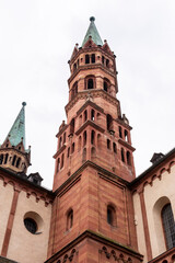 Fototapeta premium Brick colored towers with bronze green roofs at Würzburger Cathedral or Würzburger Dom seen in frog perspective from the nave side