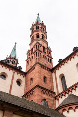 Fototapeta na wymiar Brick colored towers with bronze green roofs at Würzburger Cathedral or Würzburger Dom seen in frog perspective from the nave side