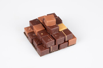 assortment chocolate pralines in pyramid view in white background