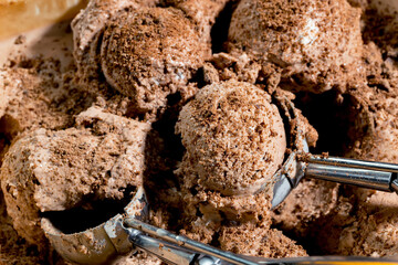 Round balls of sweet ice cream with ice cream scoop