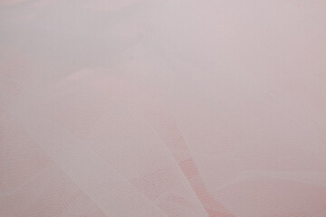 delicate airy white fabric with folds on a pink background