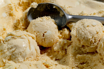 Round balls of sweet ice cream with ice cream scoop