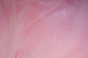 delicate airy white fabric with folds on a pink background