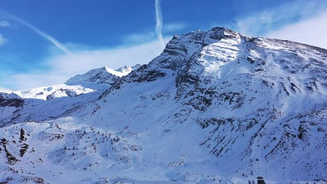 Coniferous forest and snowy mountains of Simplon Pass in Switzerland.