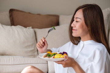 Portrait image of a young woman eating vegetables, Vegan, Clean food, dieting concept