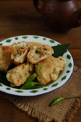 a plate of fried tofu filled with vegetables named tahu isi in Bahasa 