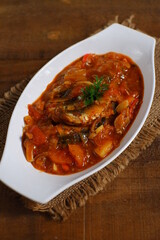 a plate of sardines cooked in spicy sauce 