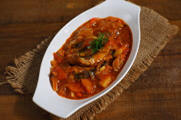 a plate of sardines cooked in spicy sauce 