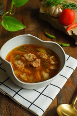 a bowl of beef cooked in spicy soup named asem asem in Bahasa 