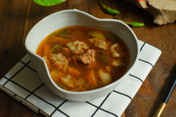 a bowl of beef cooked in spicy soup named asem asem in Bahasa 