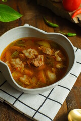 a bowl of beef cooked in spicy soup named asem asem in Bahasa 