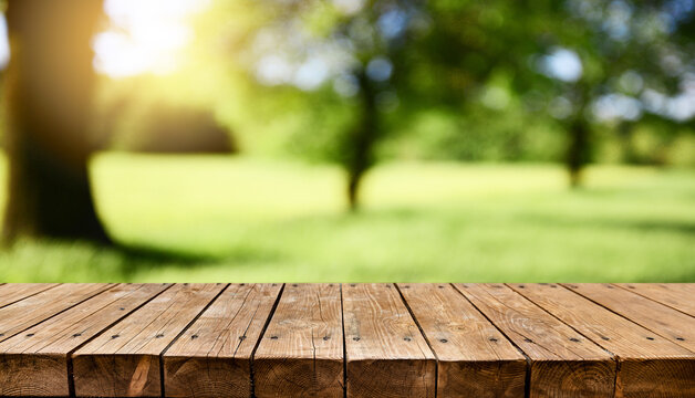 Old empty wooden table - green spring background
