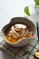 a bowl of beef cooked in spicy soup named asem asem in Bahasa 