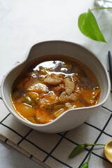 a bowl of beef cooked in spicy soup named asem asem in Bahasa 
