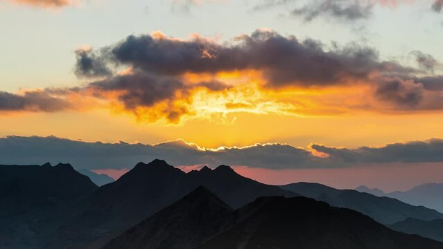 Amazing Orange Sunset Through Clouds Over French Alps Mountains