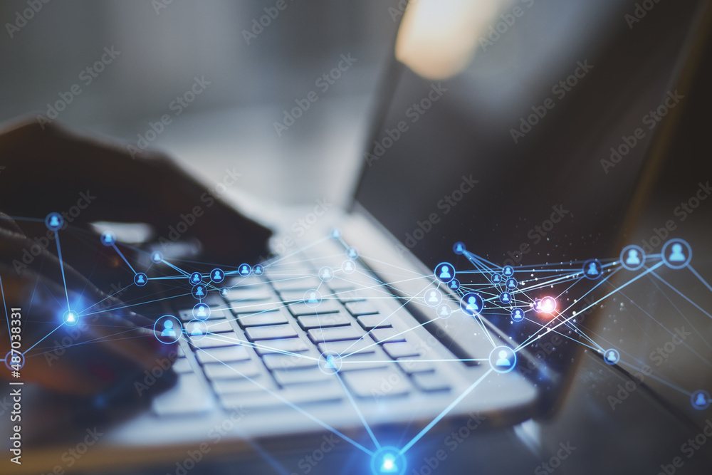 Poster close up of blurry hands at desktop using laptop with abstract glowing polygonal network with people