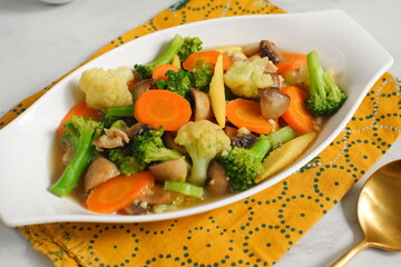 a plate of sauteed vegetables named cap cay 