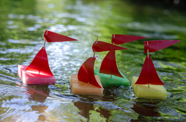 Regatta of homemade sailboats. Sailboats from kitchen sponges.