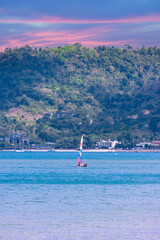 Long tail Boat on colourful sunset over a Beach in Phuket Thailand