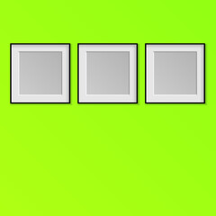 three poster frames isolated on a green background