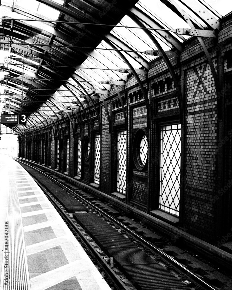 Wall mural Grayscale view of a modern railway track with modern walls