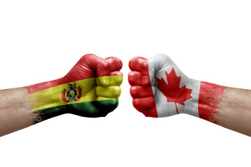 Two hands punch to each others on white background. Country flags painted fists, conflict crisis concept between bolivia and canada - obrazy, fototapety, plakaty