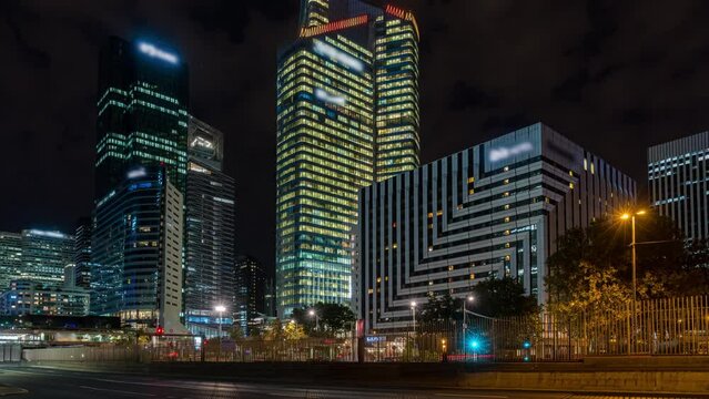 Road Traffic at Night With La Defense Business District Behind Paris Lights Towers