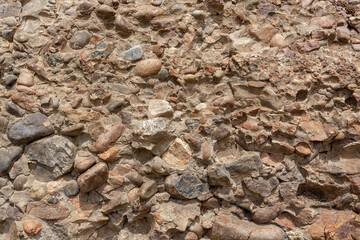 A rock consisting of various small stones. Horizontal.