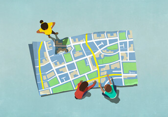 View from above kids looking at large map
