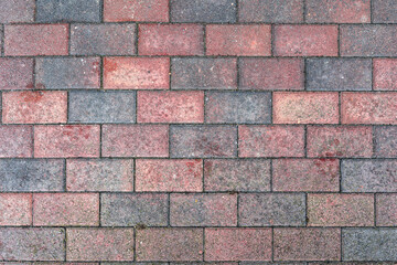 Red old stone pavement with abstract pattern closeup. crumble with age. construction, repair. concept of destruction, decline. High quality photo