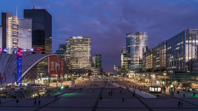 La Defense Business District Paris at Evening With Employees Under Purple and Stormy Sky