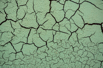 Cracked and damaged painted surface of a building or wall. Texture, aged paint background