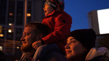 Happy family look at the sky at the fireworks.