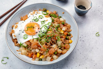 Shrimp fried rice with vegetables and fried egg