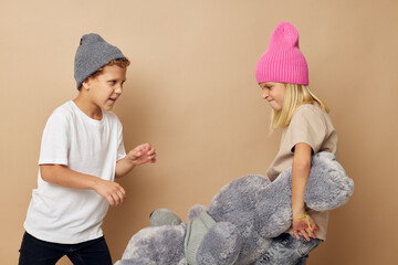 Cute stylish children in hats with a teddy bear friendship Lifestyle unaltered