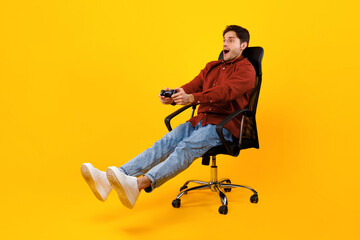 Gamer Guy Playing Video Game Holding Controller Sitting, Yellow Background