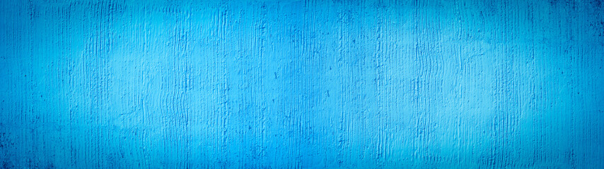 Blue painted colored abstract rough filler plaster facade wall texture background.banner panorama, with vertical line corrugation