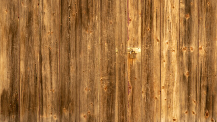 Old brown rustic dark grunge wooden timber wall texture with padlock - wood background banner..