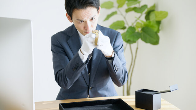 腕時計を査定する鑑定士