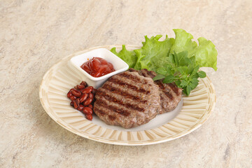Grilled beef burger cutlet with sauce