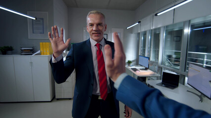Pov shot of businessman giving high five to colleague in office - obrazy, fototapety, plakaty