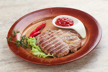 Grilled pork neck steak with ketchup