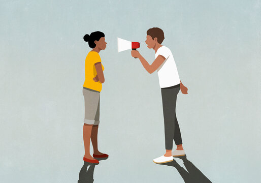 Man with bullhorn yelling at woman
