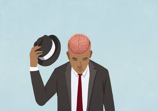 Businessman removing top hat to reveal brain
