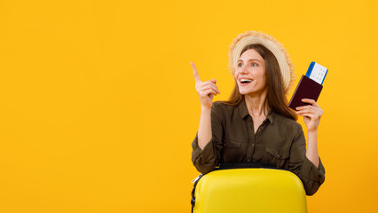 Excited Woman Tourist Pointing Fingers Aside Over Yellow Background