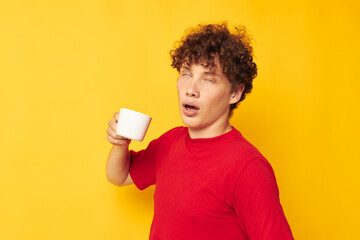 guy with red curly hair posing with a white mug and in the hands of a drink isolated background unaltered