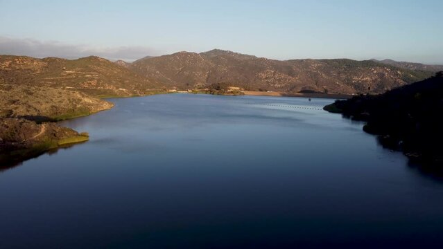 A beautiful aerial shot with a drone flying over Dixon Lake with crystal clear water in Escondido, California