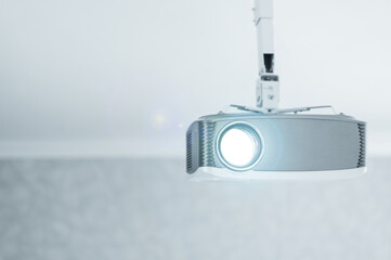 A working multimedia video projector for home theater or presentations on a ceiling mount.