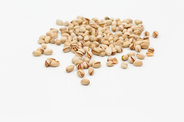 scattered pistachios on a white background